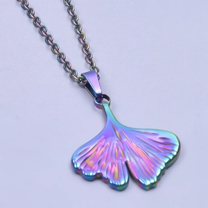 Macro shot of an iridescent ginkgo leaf pendant on a stainless steel necklace chain