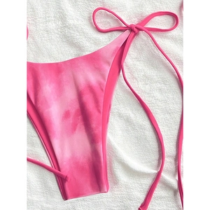 Detail of pink tie-dye bikini bottoms with high-cut design and adjustable side ties