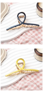 Detail of blue and yellow enamel metal hair claws on a white tray with aesthetic decor