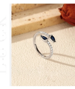 Detail of S925 silver wrap ring with blue pear gemstones and sparkling white zirconia