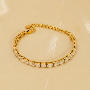 Elegant gold-plated tennis bracelet with rectangular zircon crystals on silk background