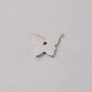 Macro shot of mirror polished stainless steel butterfly charm pendant for DIY jewelry