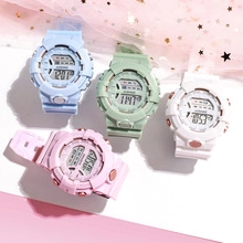 Flat lay of colorful digital nurse fob watches in blue green white and pink on pink fabric