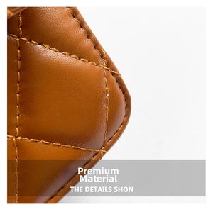 Detailed close-up of premium quilted leather texture and fine stitching on a brown bag