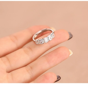 Close-up of S925 sterling silver ring with five square diamonds on model finger