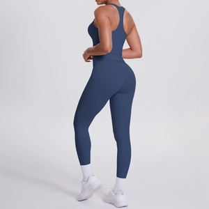 Side view of dark blue racerback sports bra and high-waisted leggings with side pocket
