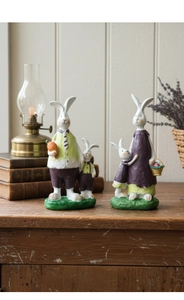 Detailed view of hand-carved resin rabbit family figures in a rustic vintage home setting
