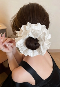 Detail of white double-layer lace scrunchie with floral embroidery on hair