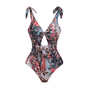 Detail of floral one-piece swimsuit with tropical print, cutout waist and tie straps