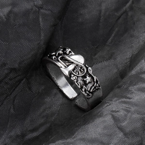 Macro detail of antique silver alloy ring featuring embossed mushroom and star patterns