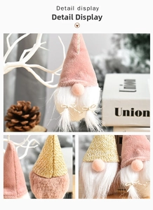 Detail view of pink velvet Christmas gnome with golden knit and white faux fur beard