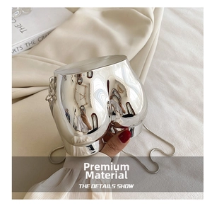 Artistic silver torso shaped mini bag with mirror finish and delicate metal chain