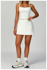 Close-up of white high-elasticity yoga tank top with racerback design and matching skirt