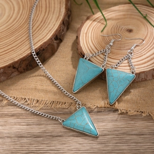 Detail of vintage turquoise triangle pendants on silver necklace and matching earrings
