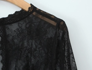 Gros plan détaillé sur la dentelle florale et les coutures d'un haut noir transparent