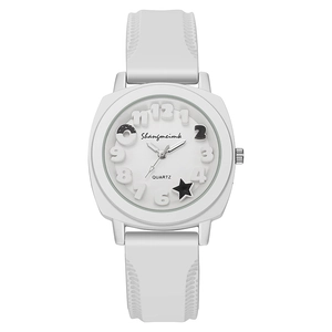 Detail of white silicone watch dial featuring 3D numbers, donut and star patterns