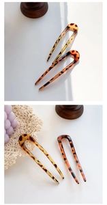 Detail view of U-shaped hairpins with tortoiseshell pattern and smooth resin finish