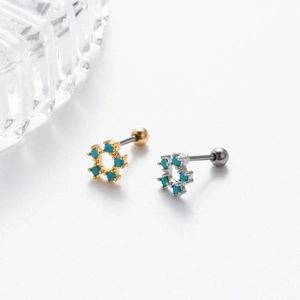 Macro detail of hexagonal turquoise screw back earrings in gold and silver finish