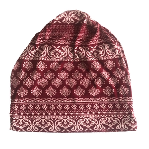 Detailed view of paisley patterns on a burgundy ethnic style slouchy knit beanie hat