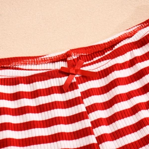 Detailed close-up of red and white striped ribbed knit fabric with a silk bow