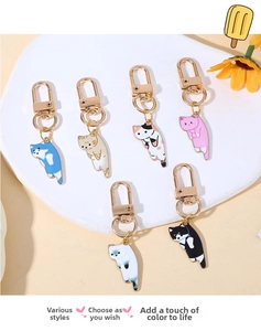 Close-up of 6 cute alloy cat charms with lobster clasps for bags and keyrings