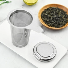 Detail view of 304 stainless steel tea infuser mesh with silicone lid on tray