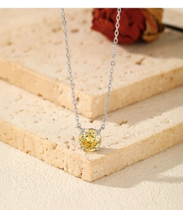 Detailed view of S925 silver necklace with yellow rose-cut zircon on beige stone
