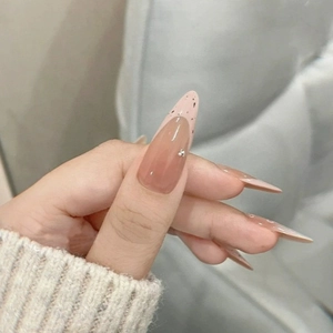 French style almond press-on nails with nude pink base, black spots and tiny pearls