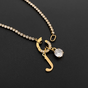 Gold plated titanium steel tennis chain necklace featuring crystal J initial pendant