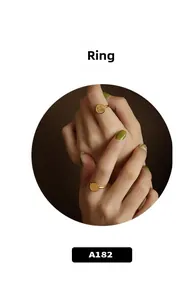 Detail of a 18k gold plated stainless steel ring with a round Fu character charm