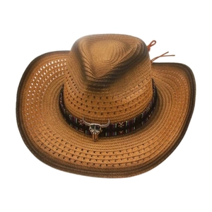 Detail of western cowboy straw hat featuring ethnic band and silver bull skull ornament