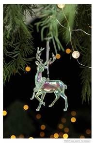 Detailed view of iridescent acrylic reindeer ornament hanging on a festive Christmas tree