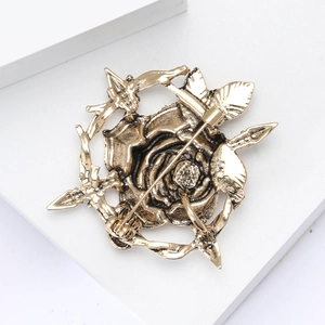 Macro view of the retro gold alloy rose brooch showing the secure pin back clasp