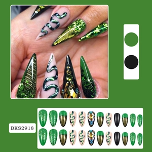 Detail of green and black press-on nails with snake pattern and rhinestone design BKS2918