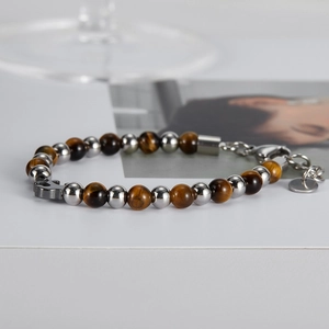 Detailed shot of tiger eye stone beads and stainless steel chain bracelet for men