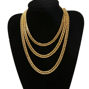 Three-layered gold titanium steel cuban link necklaces on a black mannequin display