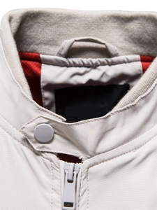 Detailed macro view of standing collar with red lining and ribbed knit interior on jacket