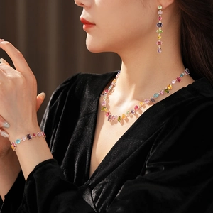 Model wearing a luxury rainbow zircon jewelry set with matching necklace, bracelet and earrings
