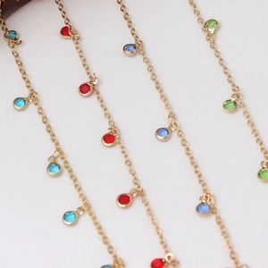 Macro shot of gold plating chain with colorful crystal pendants for DIY jewelry making