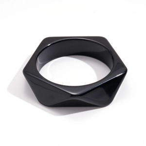 Minimalist black resin hexagonal bangle with geometric faceted edges and polished finish