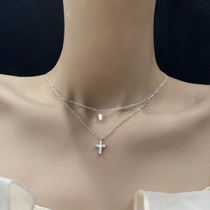 Double-layer silver necklace with sparkling cross and teardrop zirconia pendants