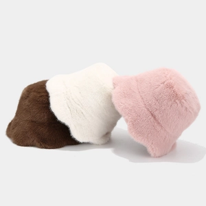 Detailed view of plush faux fur bucket hats in brown white and pink soft texture