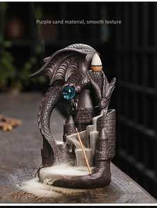 Macro view of purple sand dragon incense burner with waterfall smoke and castle detail