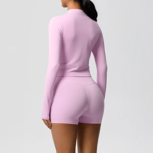 Back view of pink tight-fitting yoga set featuring long sleeve top and athletic shorts
