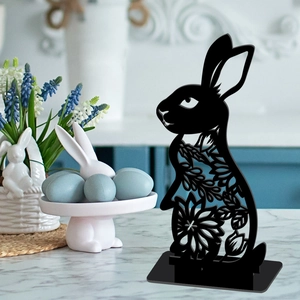Detailed close-up of a black hollow rabbit silhouette stand on a wooden desktop base