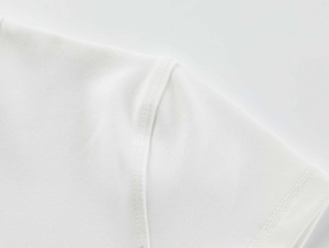 Detailed close-up of neat shoulder stitching on a white elastic slim-fit sports t-shirt