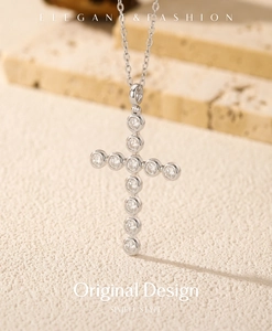 Macro view of S925 silver cross pendant featuring eleven brilliant round-cut moissanite stones