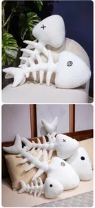 Detail of white fishbone plush pillows in various sizes with creative embroidered expressions