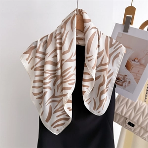 Elegant beige and brown zebra print silk square scarf styled over a black dress