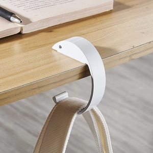 Minimalist white portable desk hook for school bags on a wooden tabletop edge
